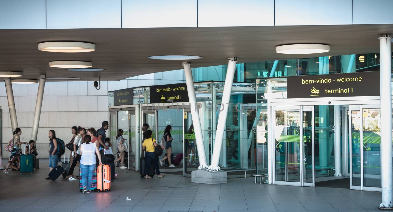 Lisbon, Portugal - August 7, 2018: exterior view of Lisbon International Airport where travelers walk on a summer day