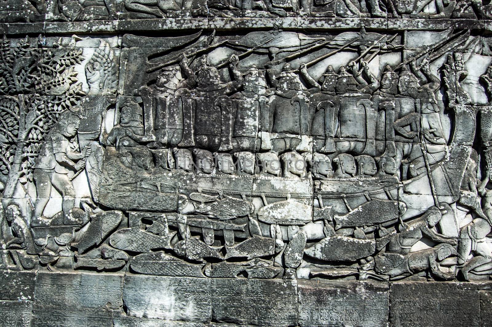 Ancient Khmer bas relief carving showing Cham fighters taking part in a naval battle on the Tonle Sap lake in Cambodia. Bayon Temple, Angkor Thom, Siem Reap, Cambodia.