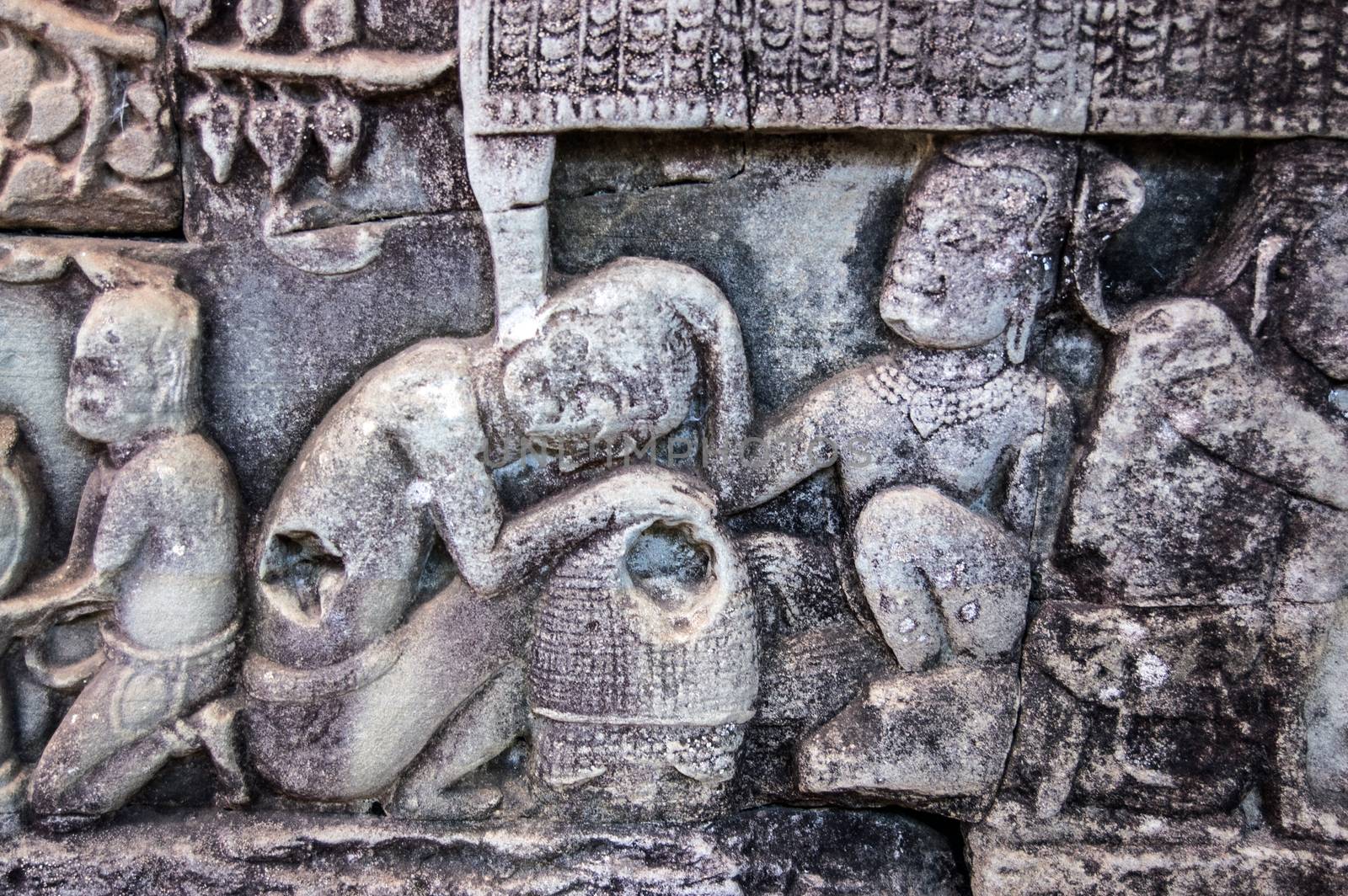 Ancient Khmer carving of lice being picked out of a woman's hair. Wall of Bayon Temple, Angkor Thom, Cambodia.