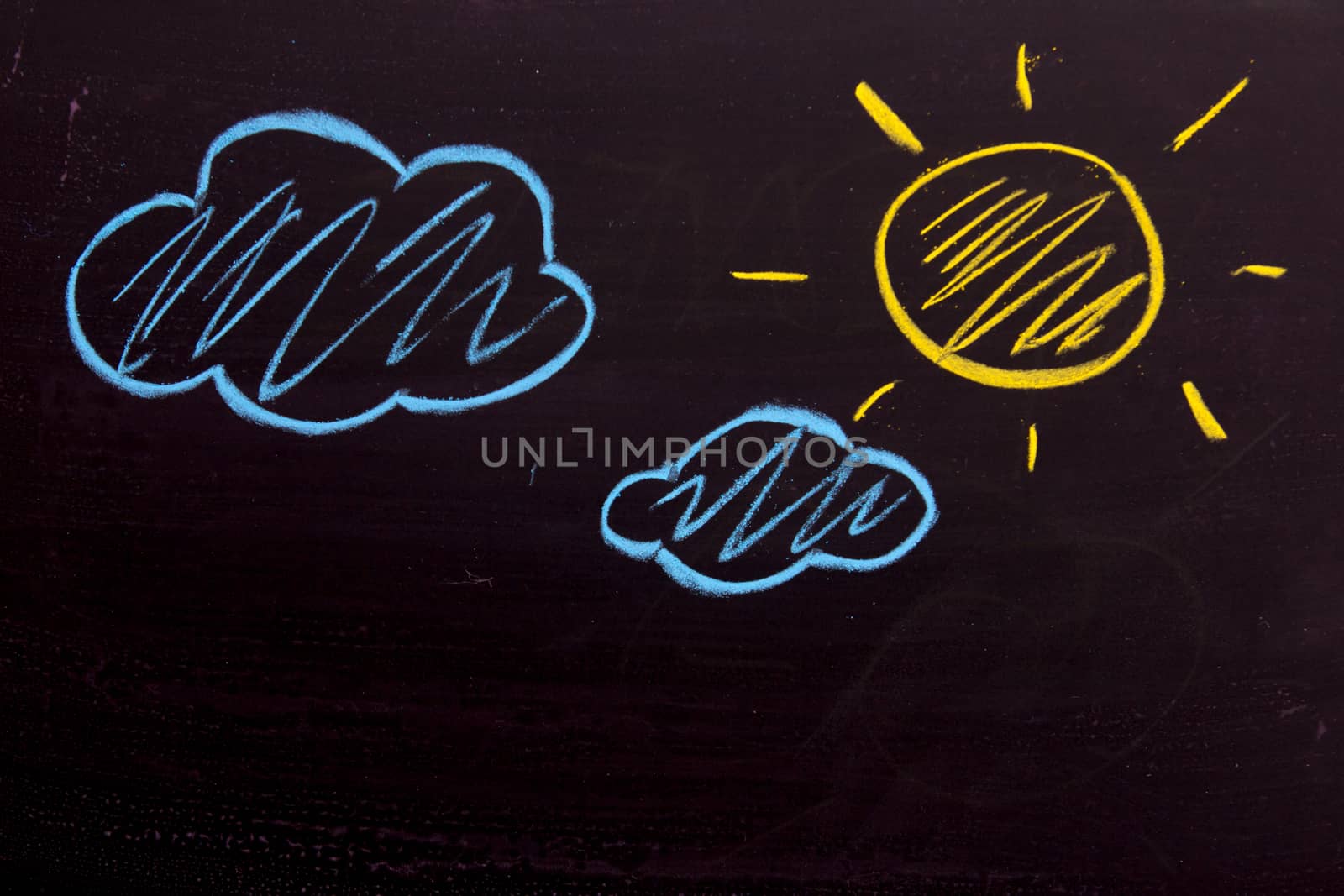 Chalk drawing as yellow sun and blue cloud background