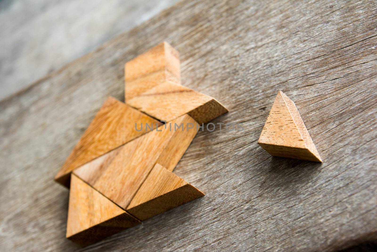 Wooden tangram puzzle wait to fulfill home shape for build dream by Hengpattanapong