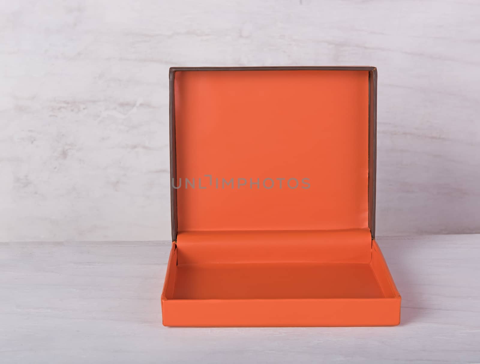 Orange gift box on grunge wood background