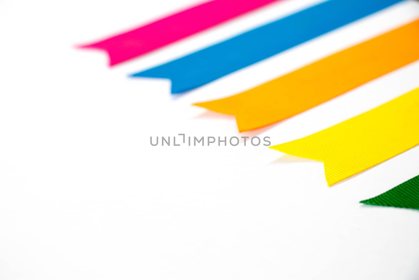 Colorful ribbon (Pink, blue, orange, yellow, green) on white background