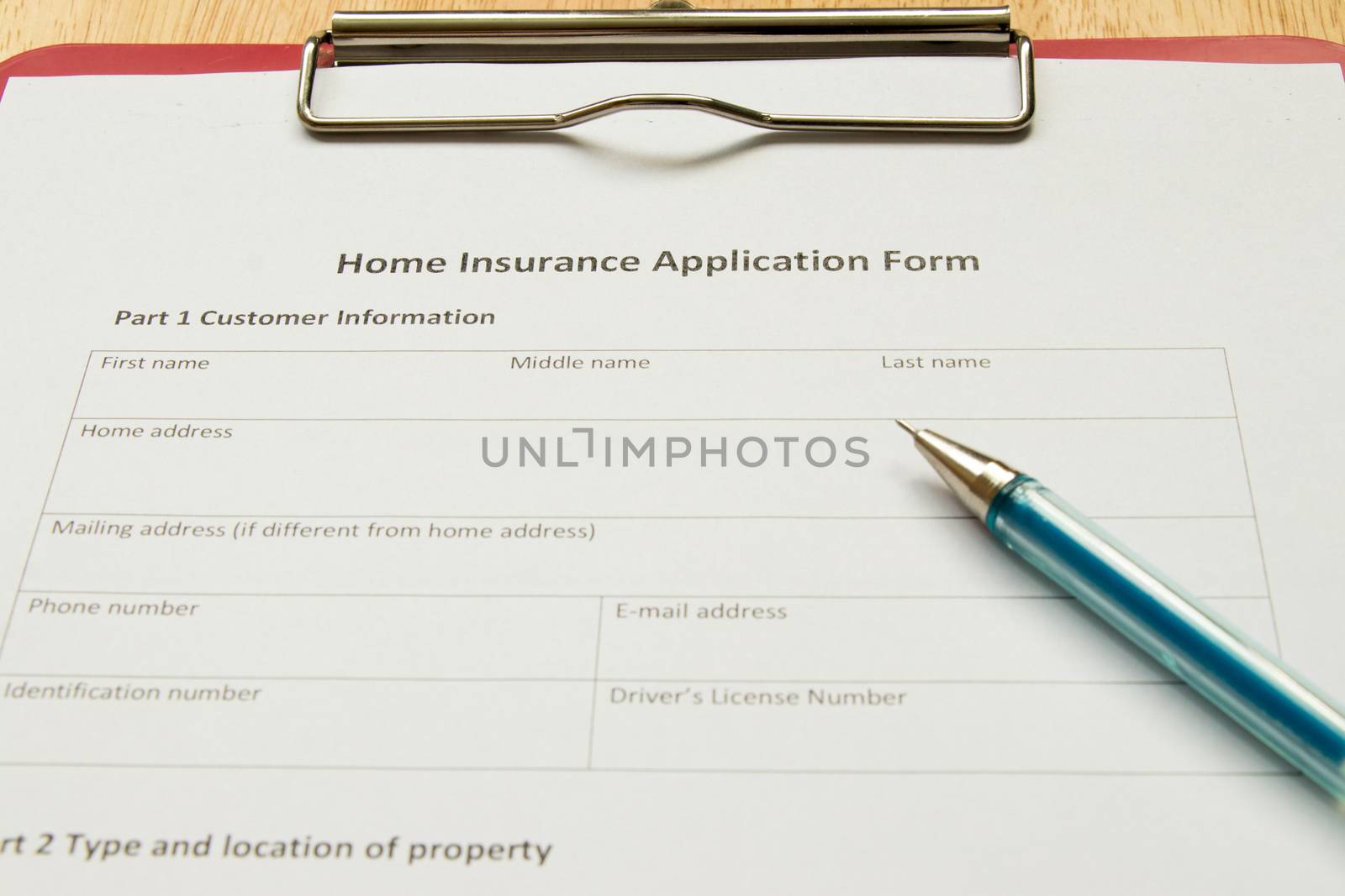 Home insurance application form with red file on wooden table by Hengpattanapong