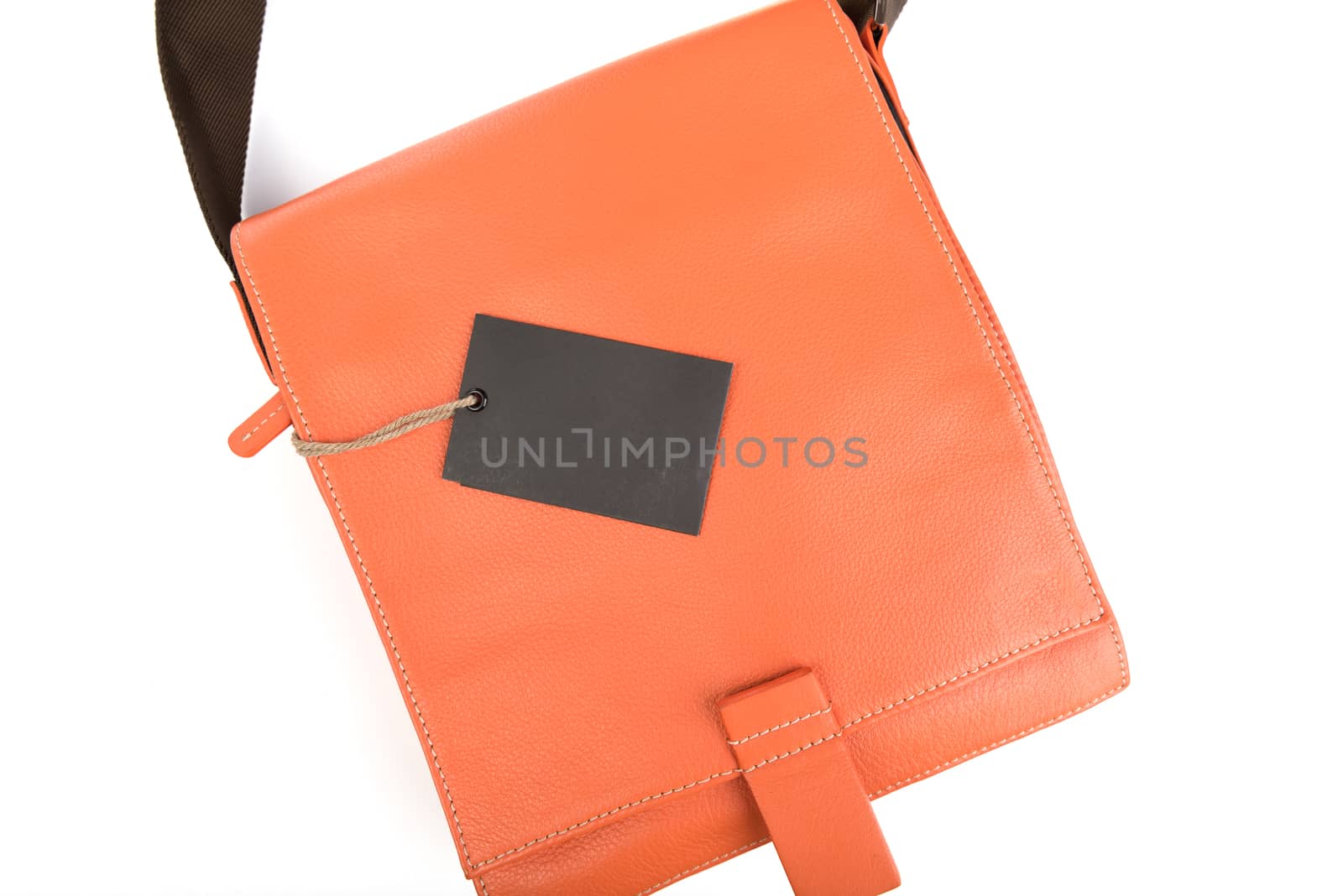 Orange leather bag with black price tag on white background