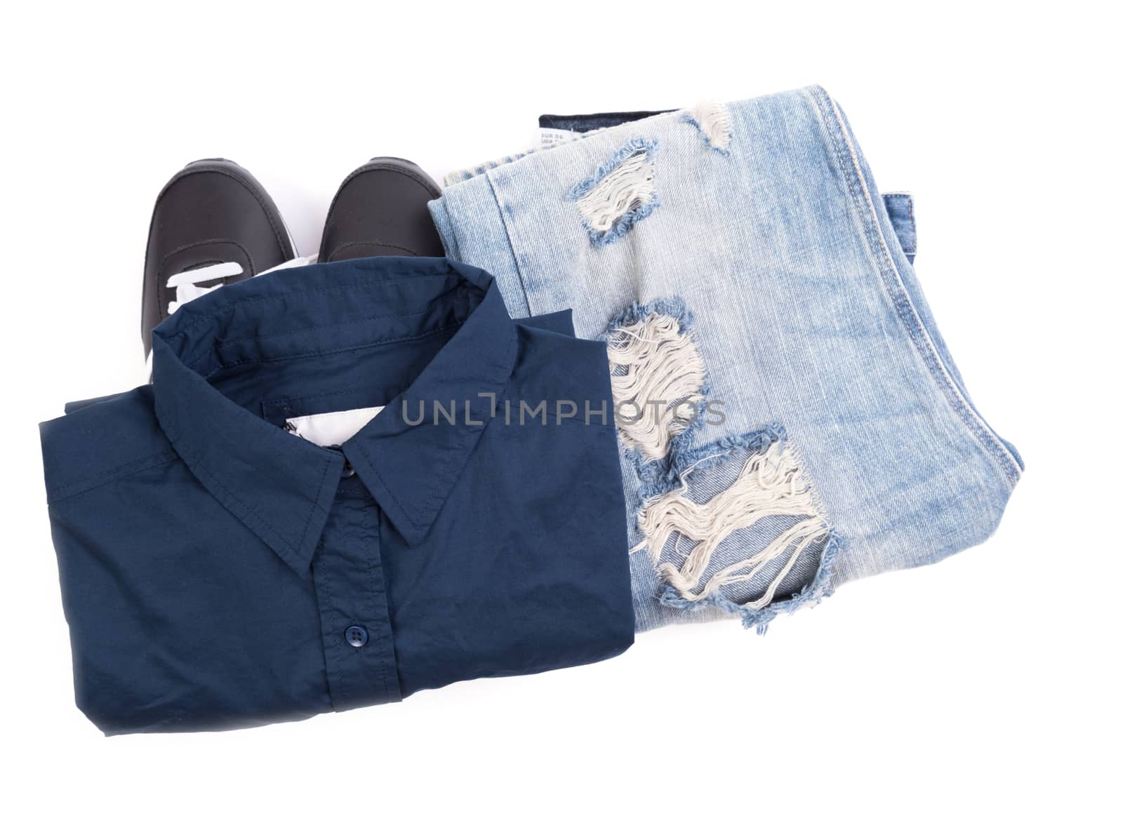 Blue shirt, jean and sport shoes on white 