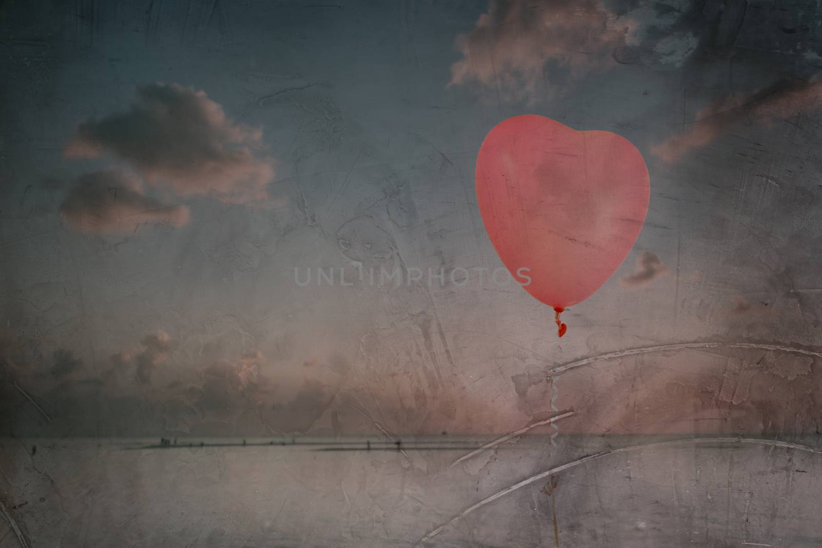 Grunge pink balloon over sea sky background with retro filter effect