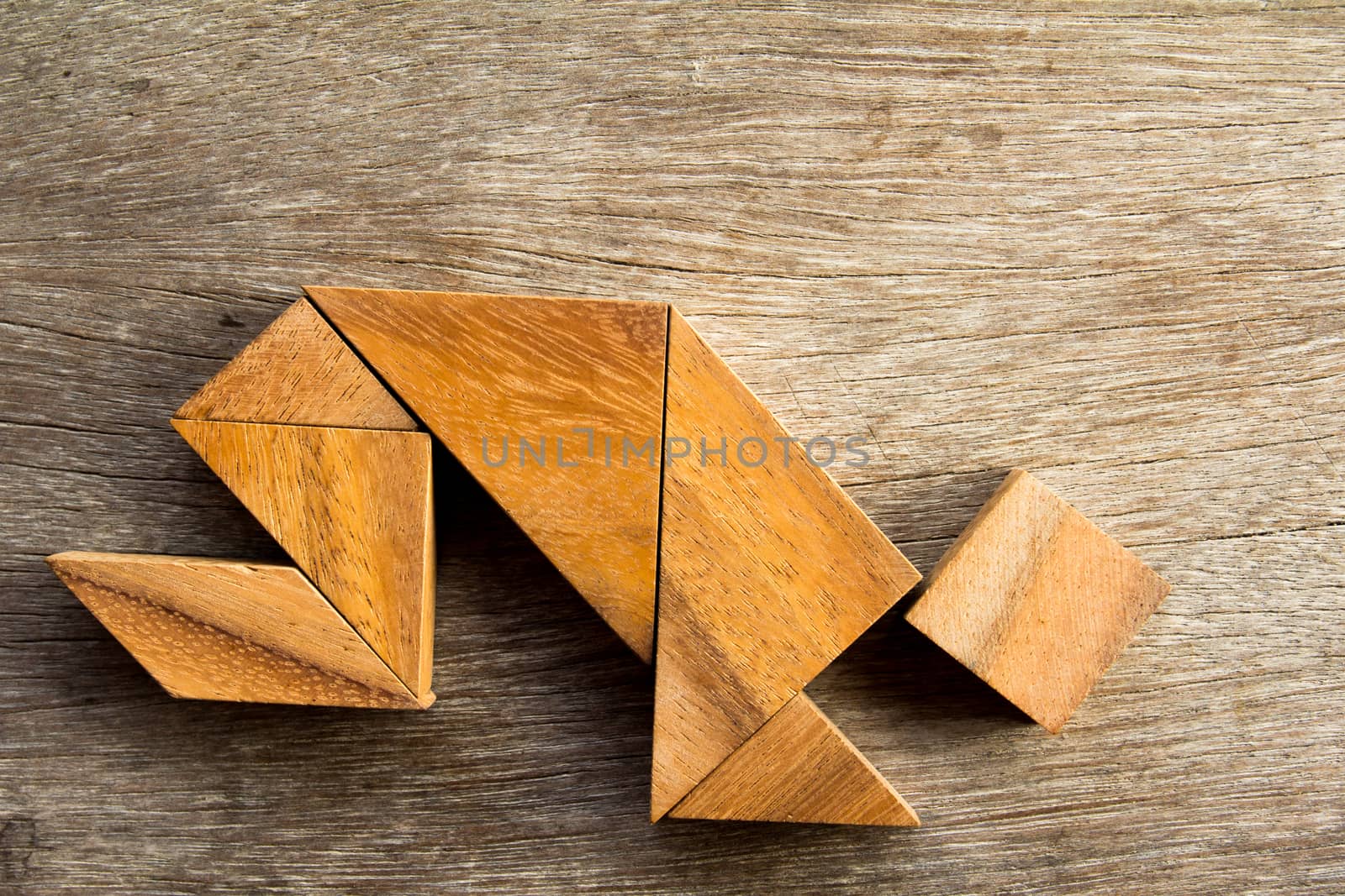 Wooden tangram puzzel in man crouch shape background