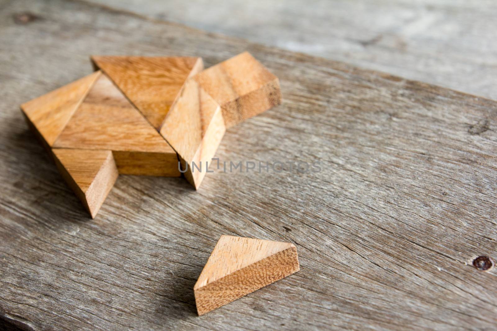 Wooden tangram puzzle wait to fulfill home shape for build dream home or happy life concept