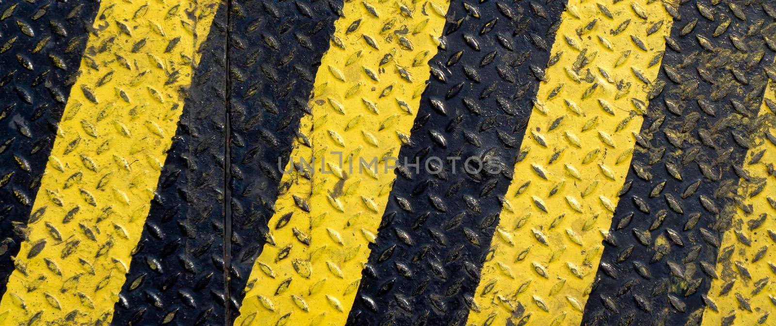 Black and yellow line paint on non-slip metal background by Hengpattanapong