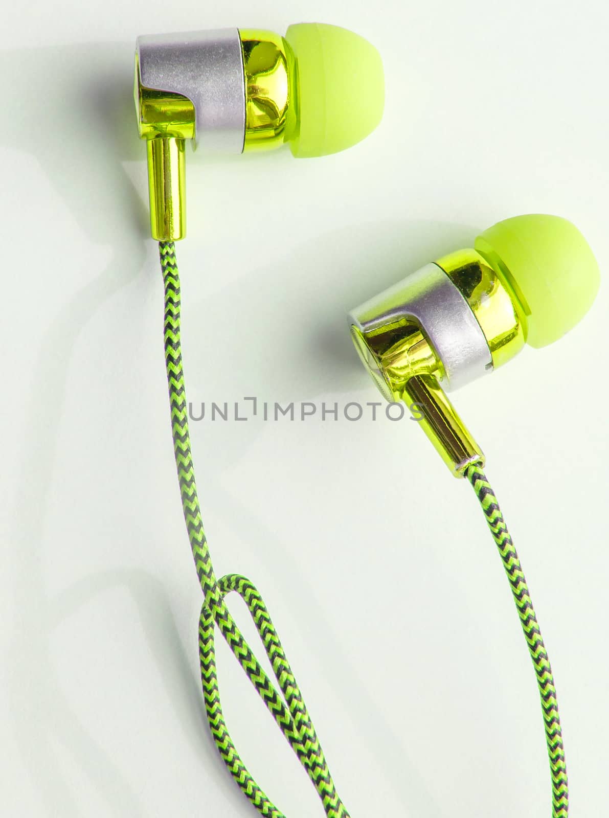 Yellow headphones on a white background close-up, vertical photo.