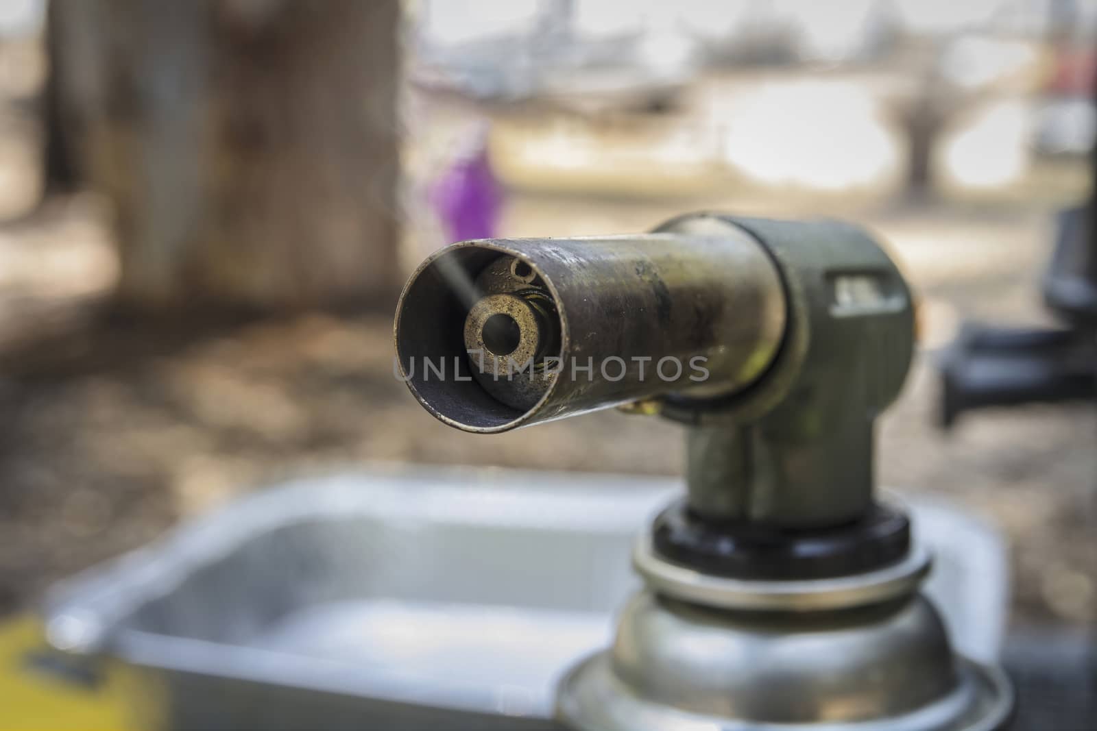 Smoke emitted from a manual gas burner. Close up with selective focus.