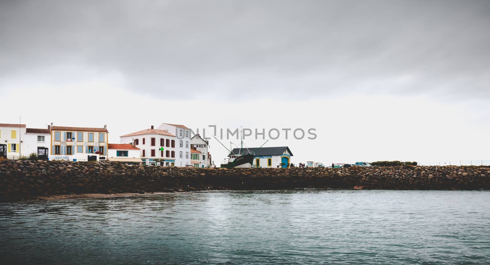 Port Joinville on the island of Yeu - September 18, 2018: entrance to the port of the island of Yeu with its semaphore and typical small houses on a fall day