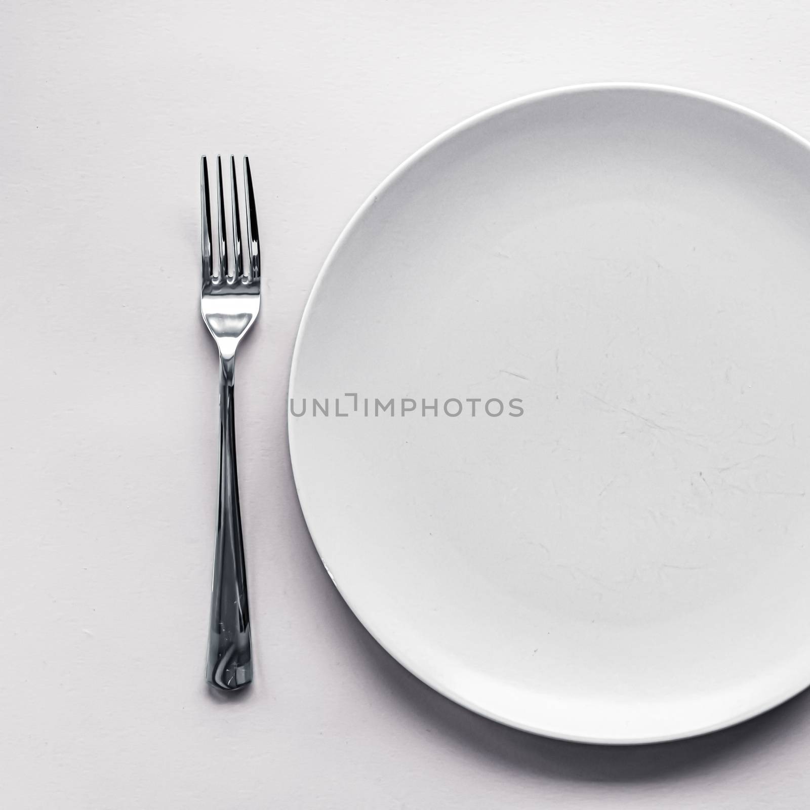 Empty plate and cutlery as mockup set on white background, top tableware for chef table decor and menu branding by Anneleven