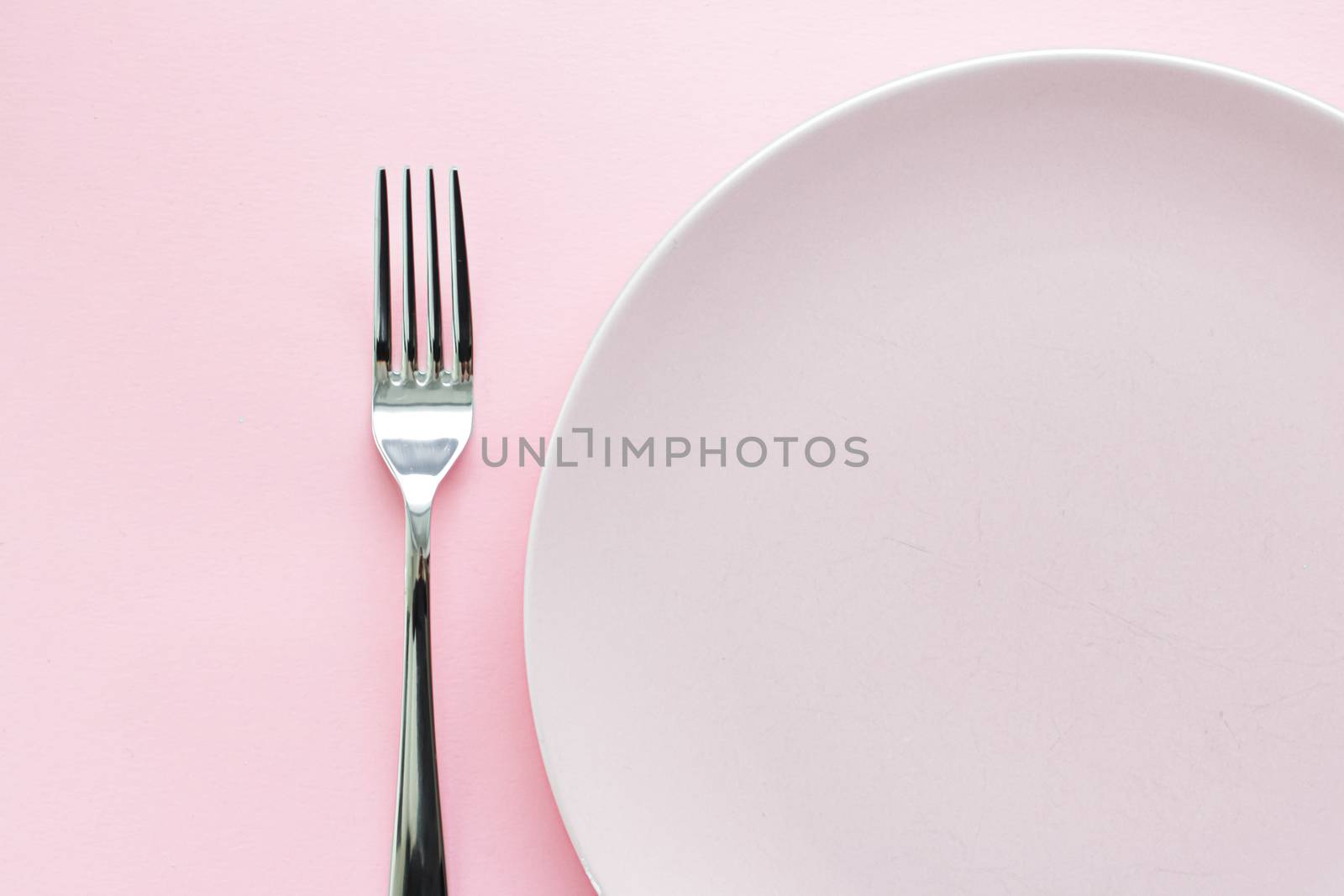 Empty plate and cutlery as mockup set on pink background, top tableware for chef table decor and menu branding by Anneleven