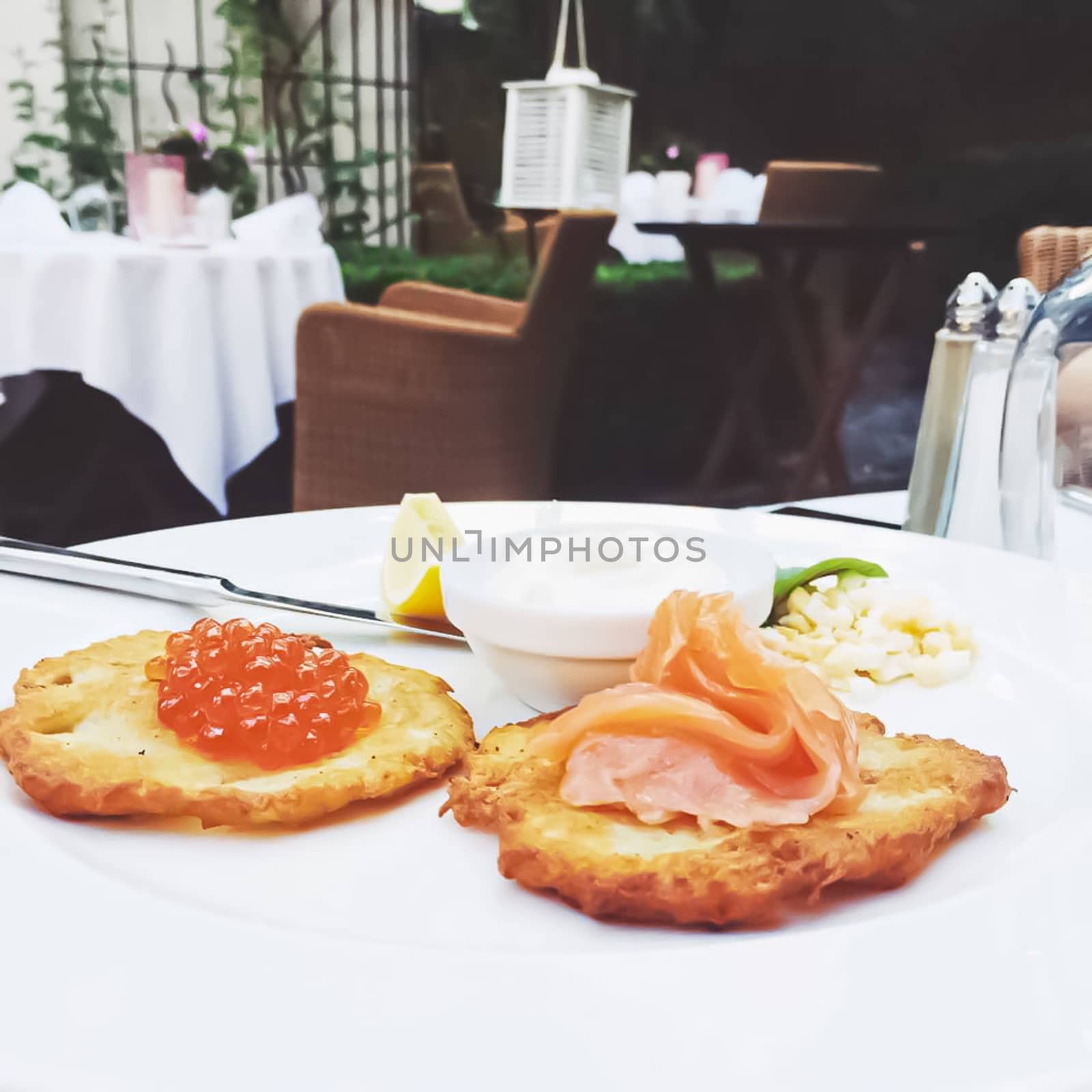 Potato pancakes with salmon and caviar in luxury restaurant, food and cuisine by Anneleven