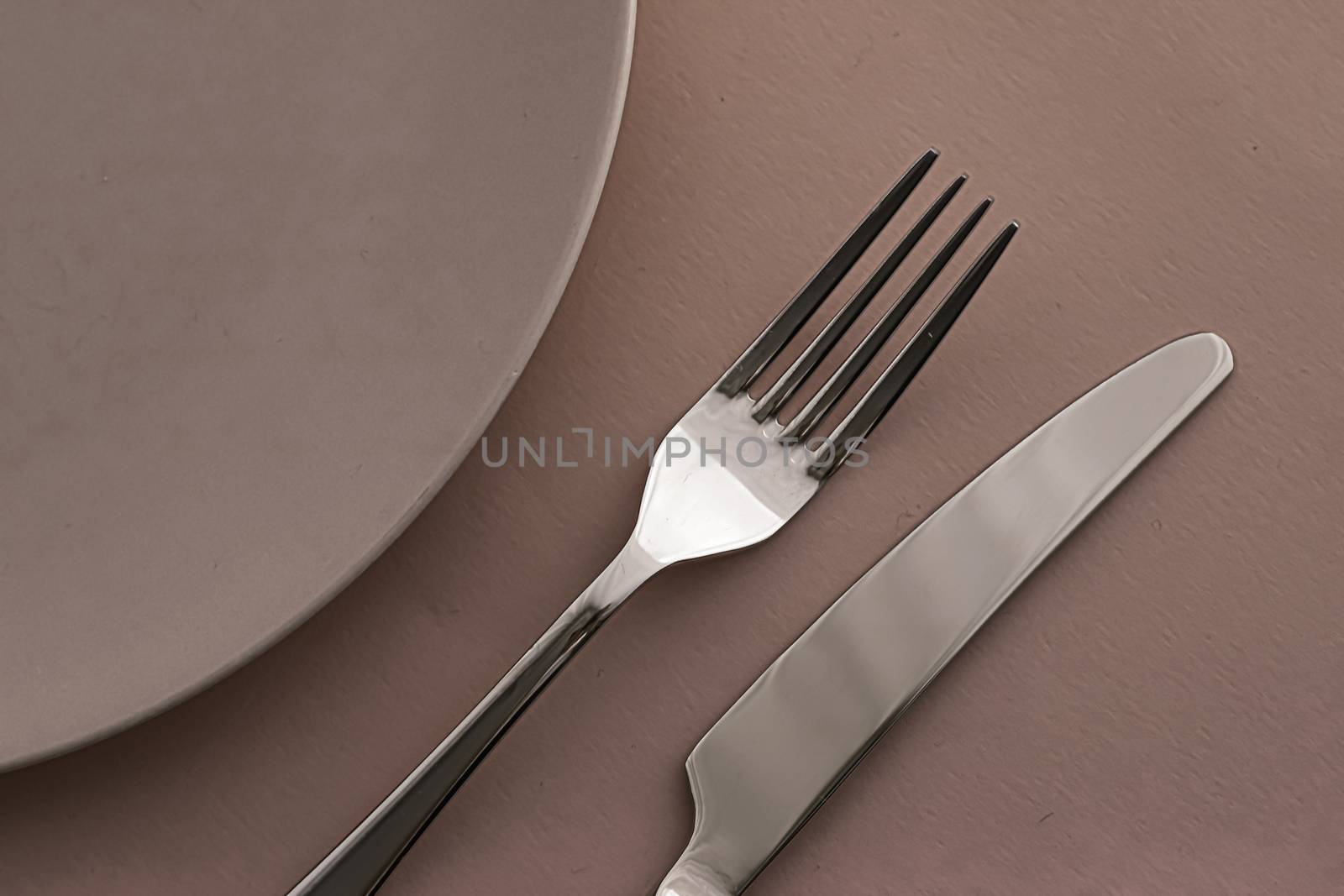 Empty plate and cutlery as mockup set on brown background, top tableware for chef table decor and menu branding design