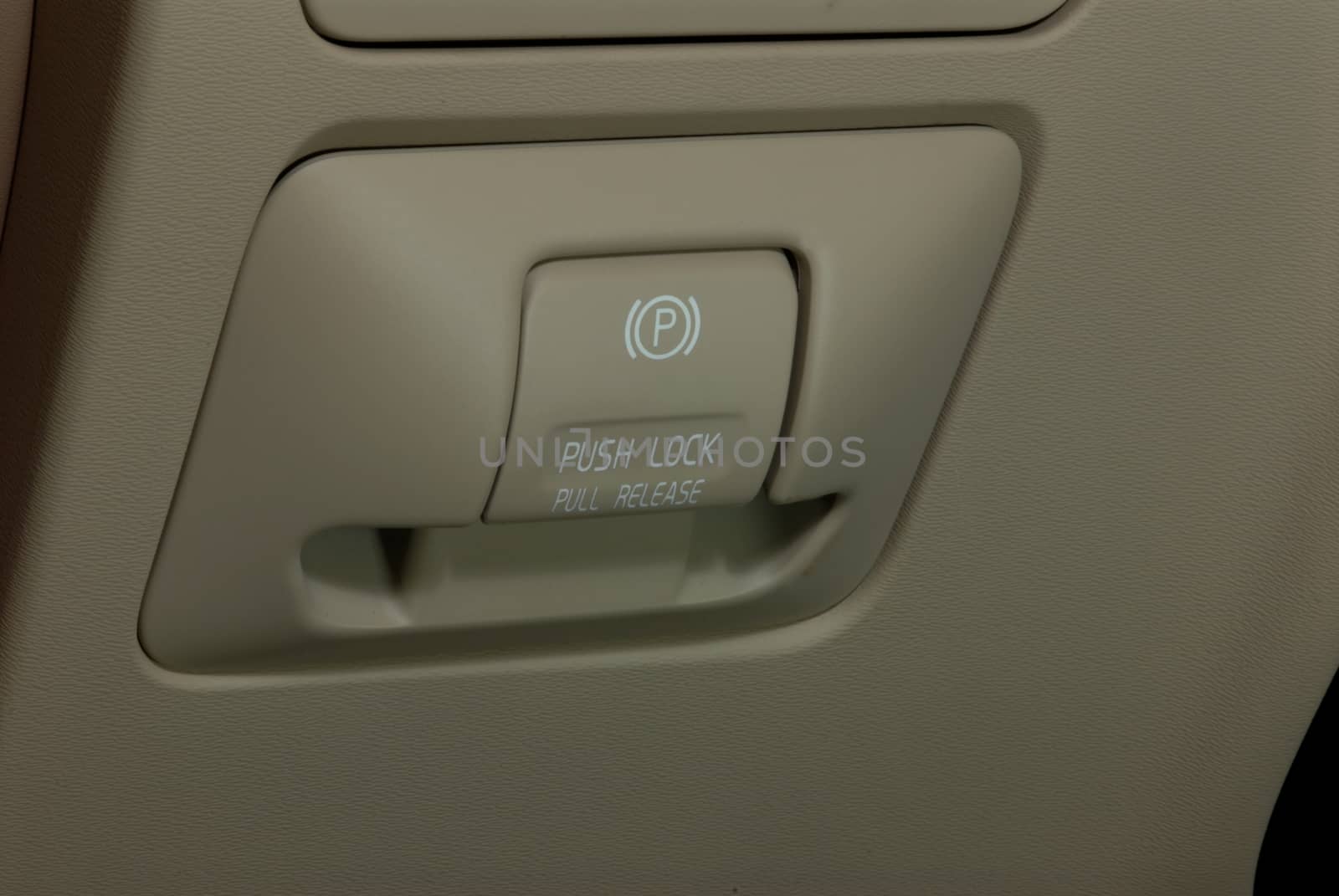 detail in a car with electric parking brake button