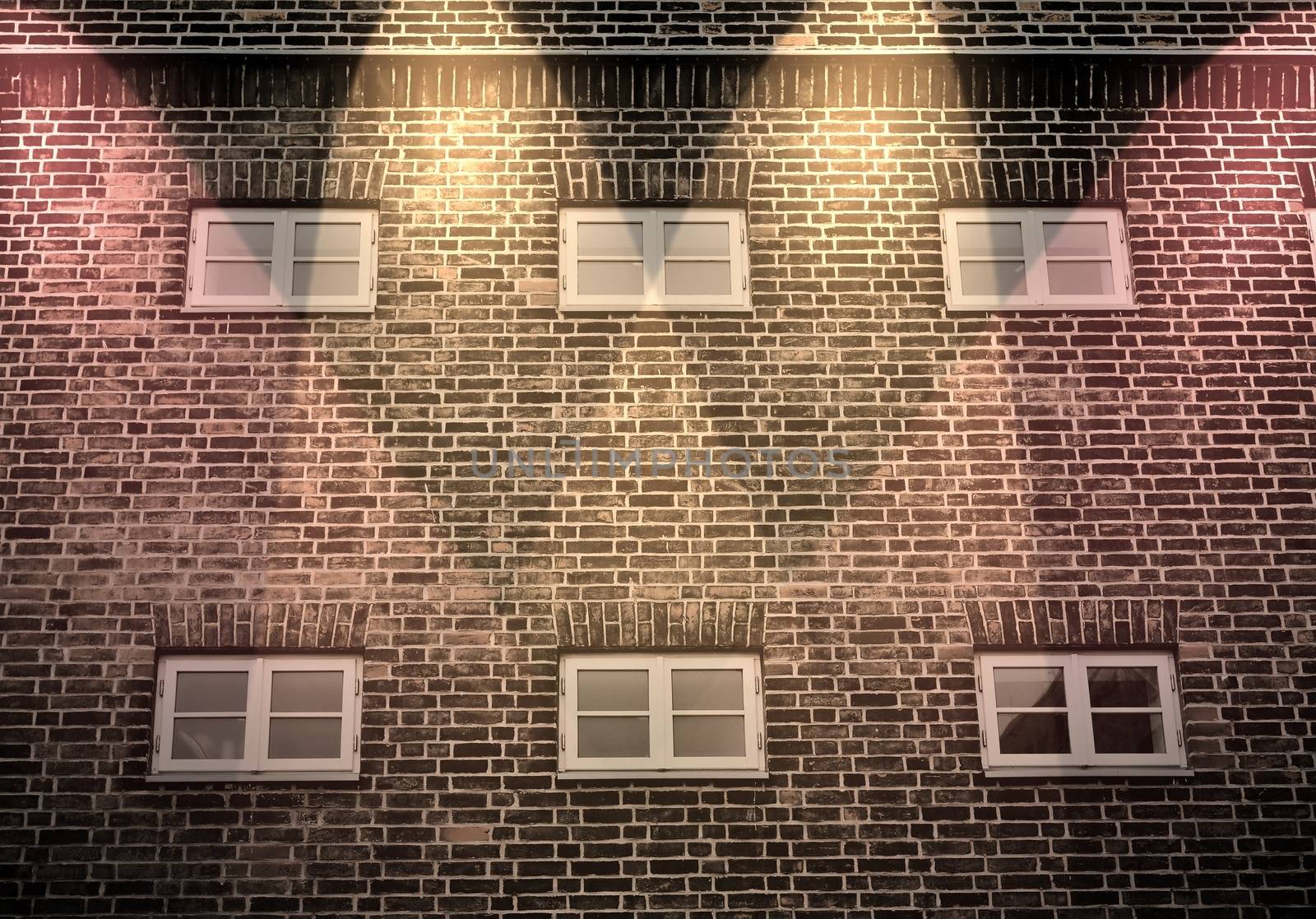 Aged and weathered brick wall textures with bright spotlight illumination