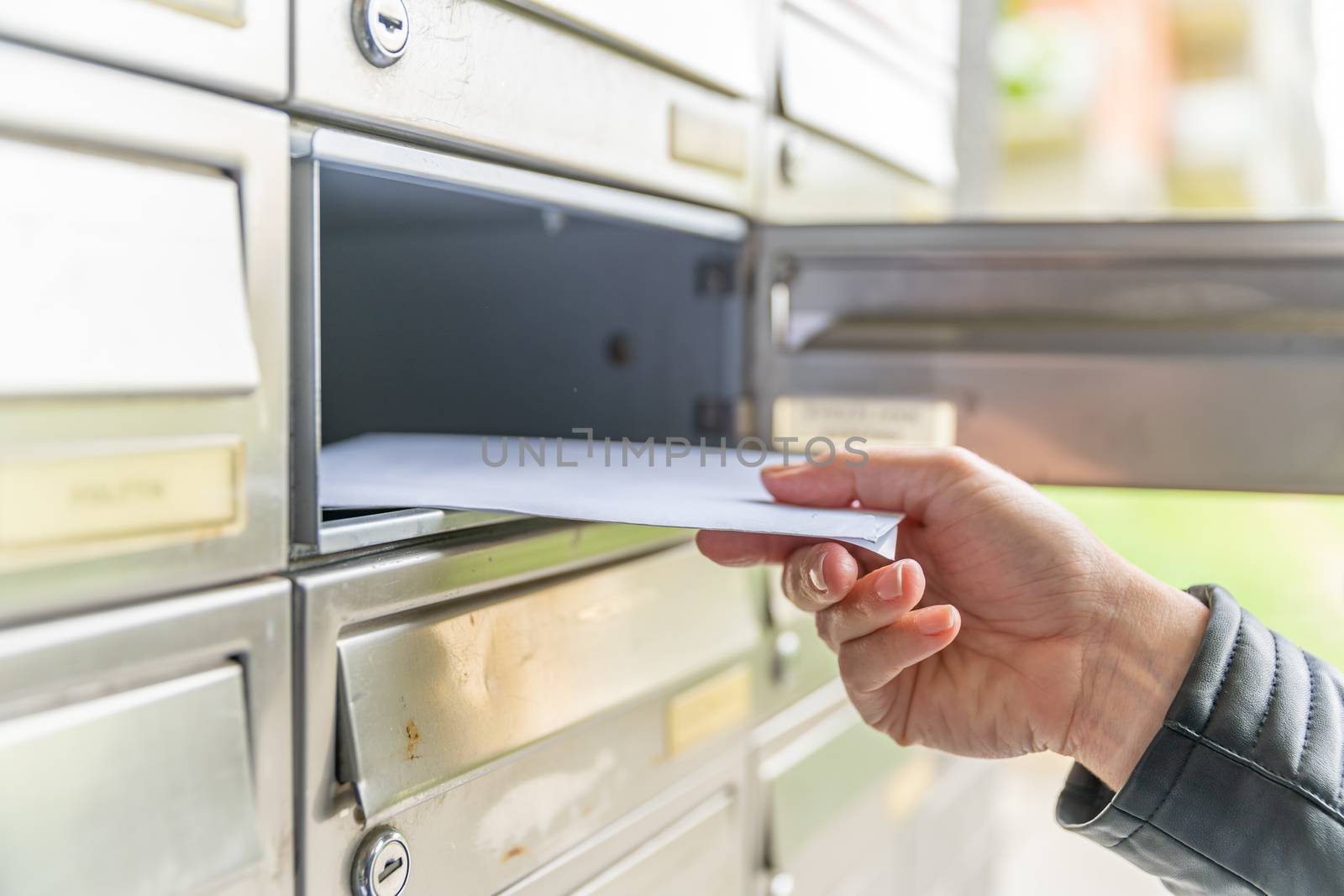 letter in the mailbox of an apartment building.