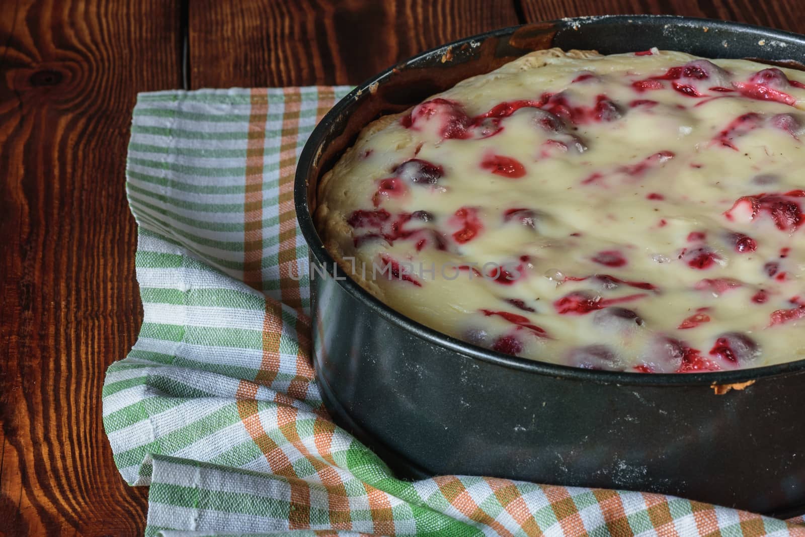 homemade strawberry cake in metal baking dish on towel