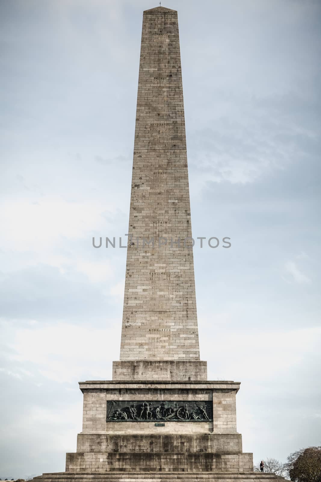 Dublin, Ireland - February 13, 2019: Tourists walking near the Testimonial Wellington obelisk in Phoenix Park, Dublin, Ireland on a winter day