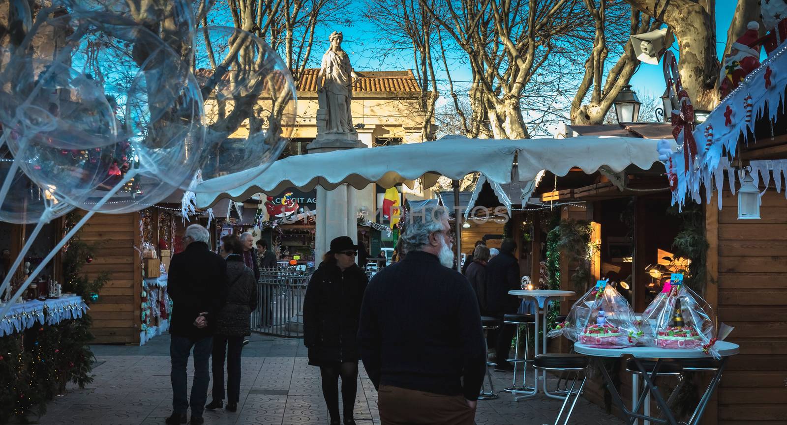 Marseillan, France - December 30, 2018: Street atmosphere in the Christmas market of the city where people walk on a winter day