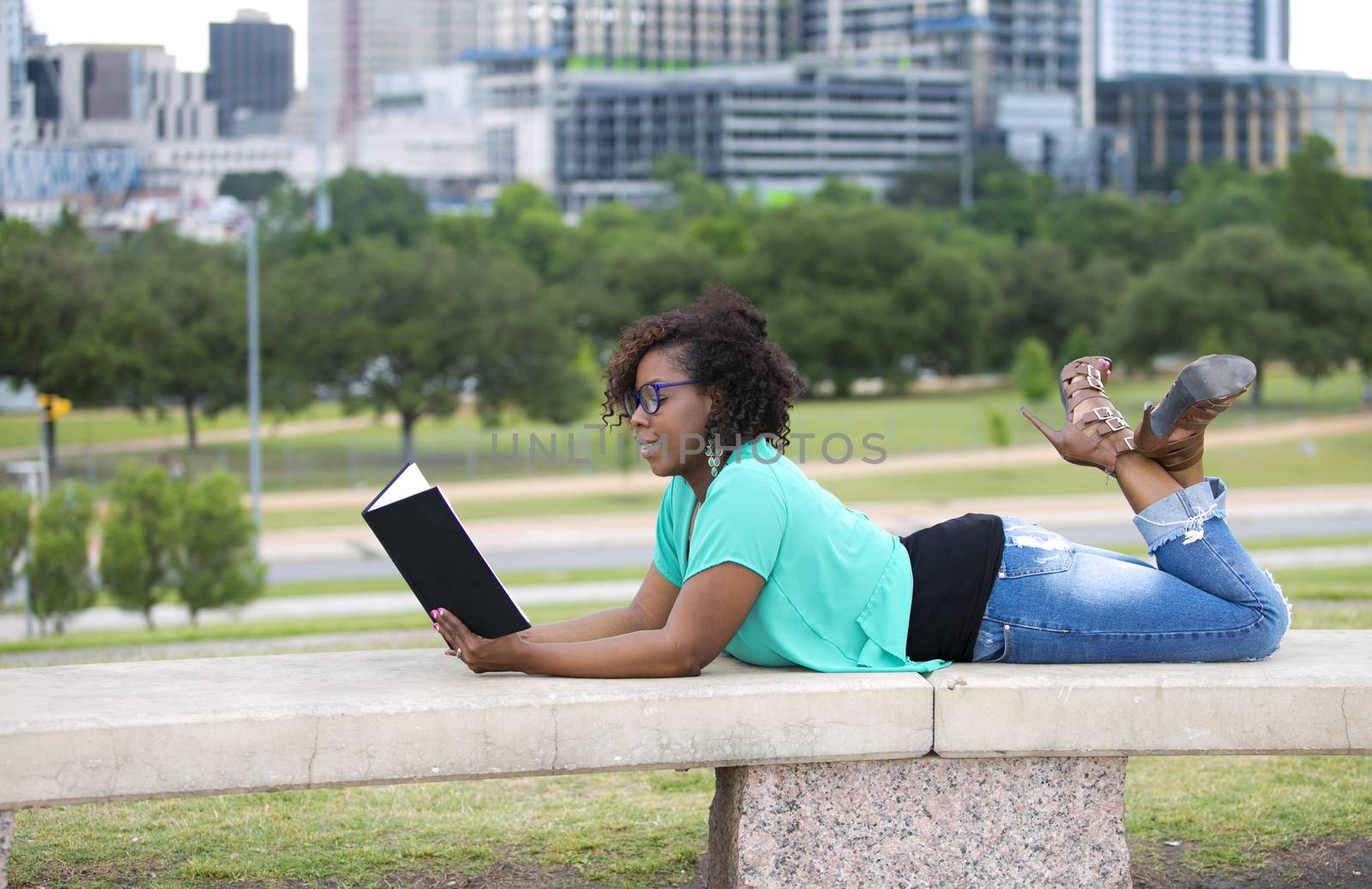 Beautiful African American woman reading a book, Austin Texas background