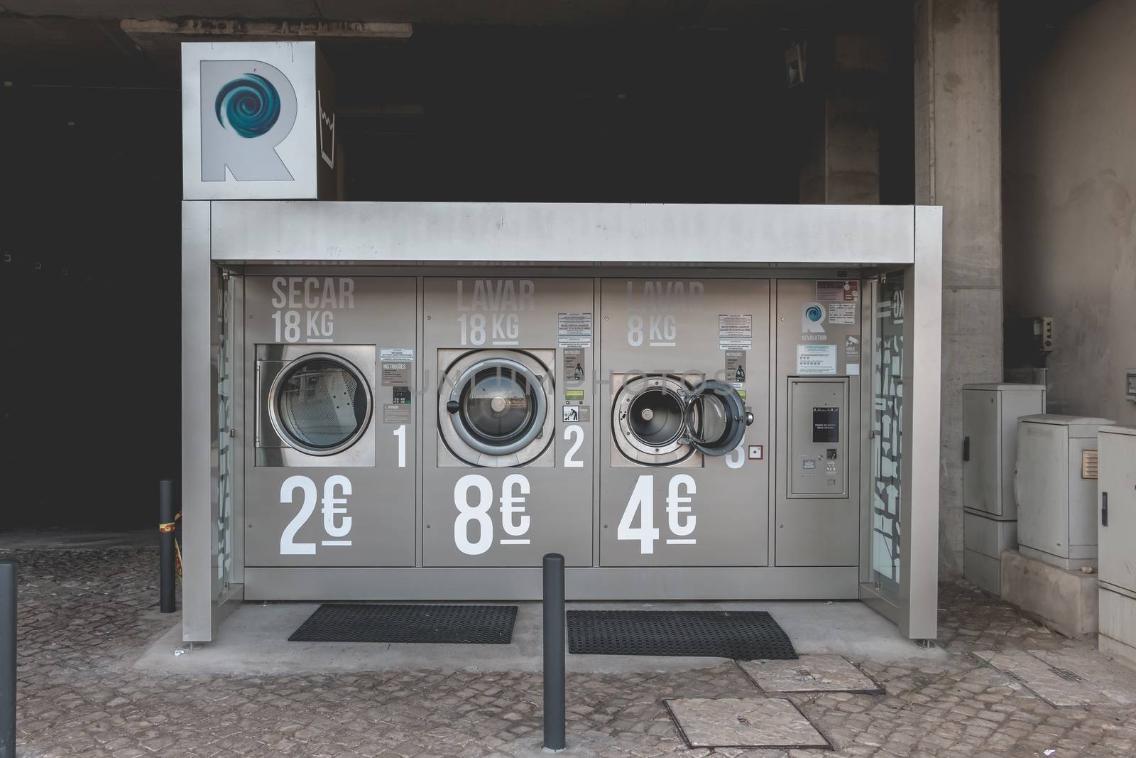 Albufeira, Portugal - May 3, 2018 - View of an automatic public washing machine in the city center on a spring day