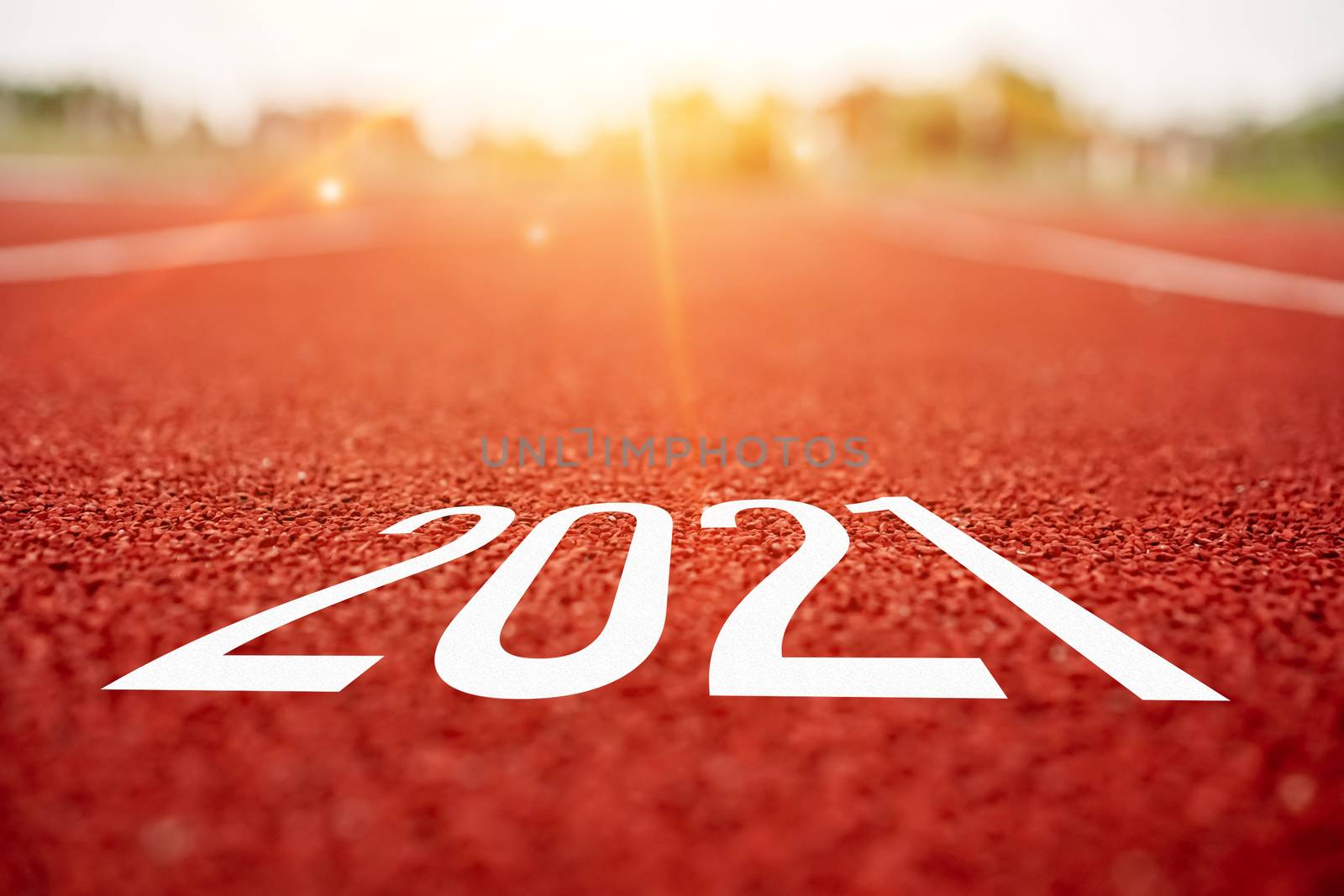 Start line to 2021 on running court represents the beginning of a journey to the destination in business planning, strategy and challenge or career path, opportunity concept.