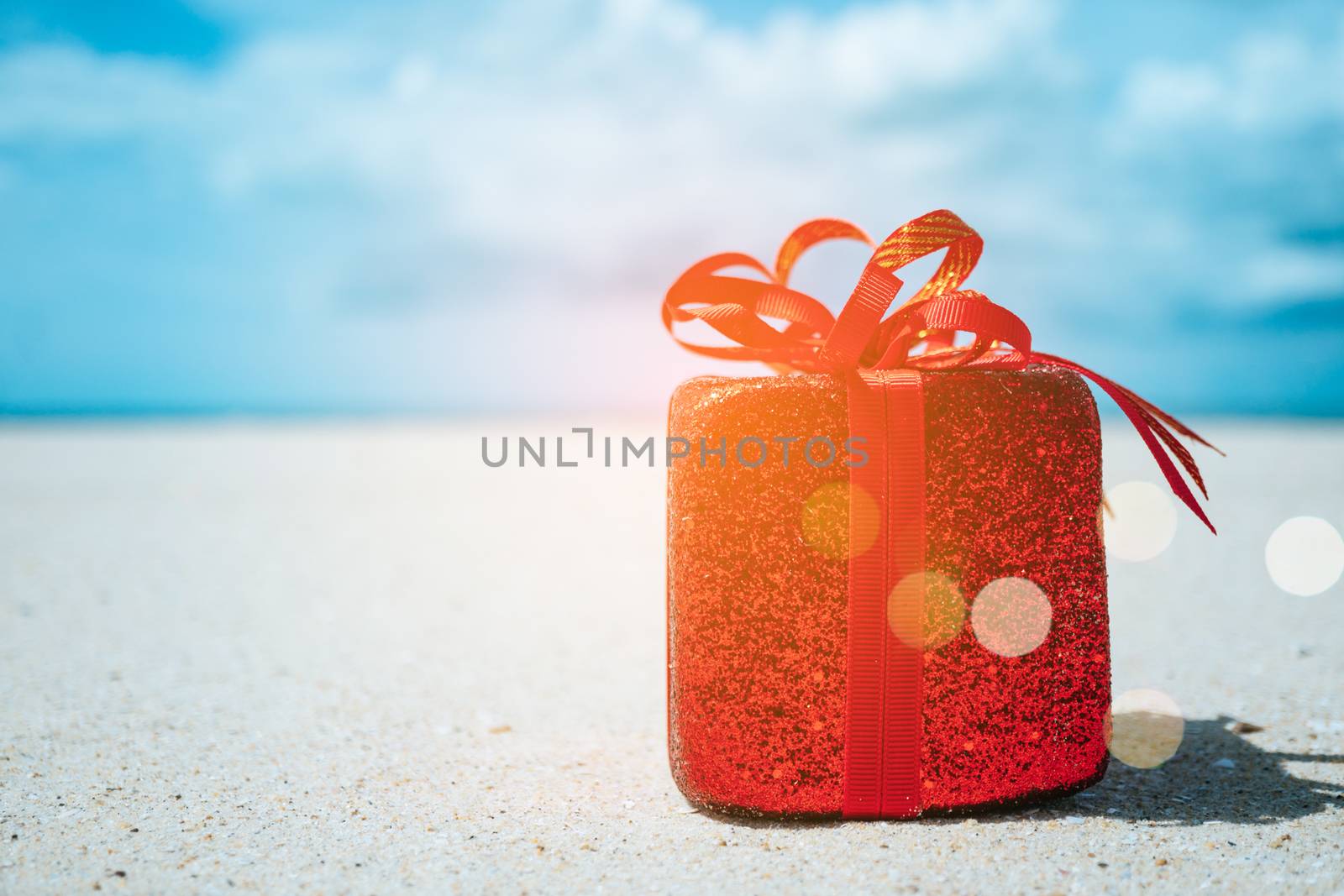 Gift boxes on sandy beach. Hot tours or holiday vacation concept with summer sea background.