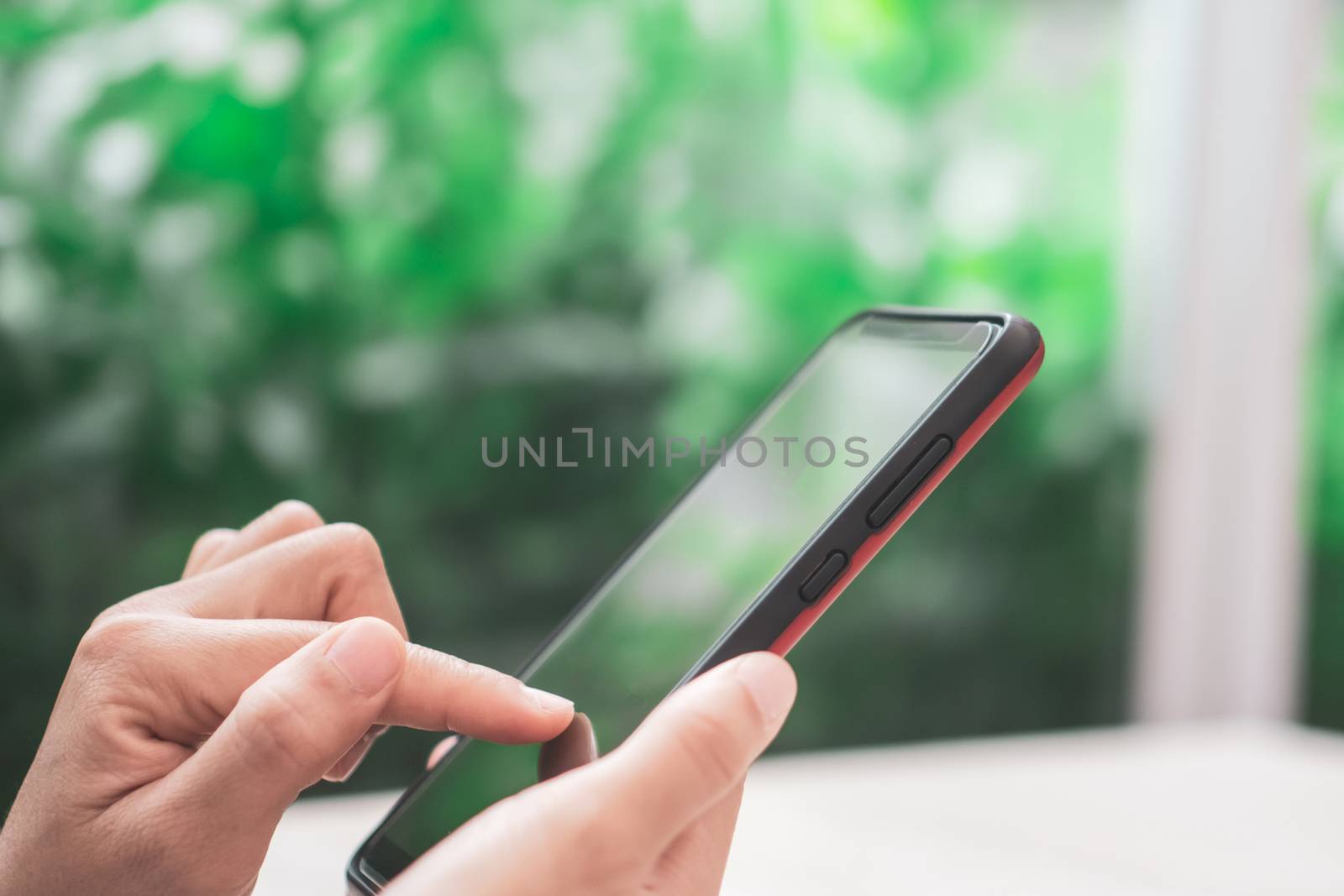 Woman hand use smartphone to do work business, social network, communication in public cafe work space area.