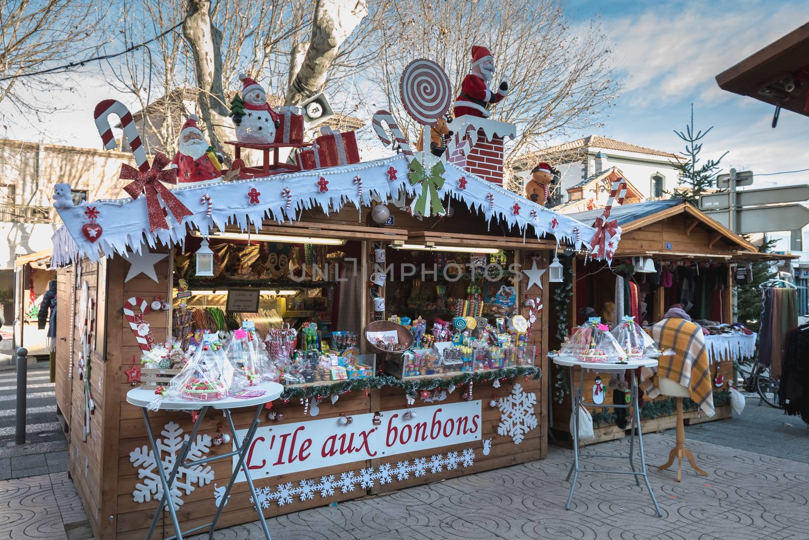 Marseillan, France - December 30, 2018: Street atmosphere in the Christmas market of the city where people walk on a winter day