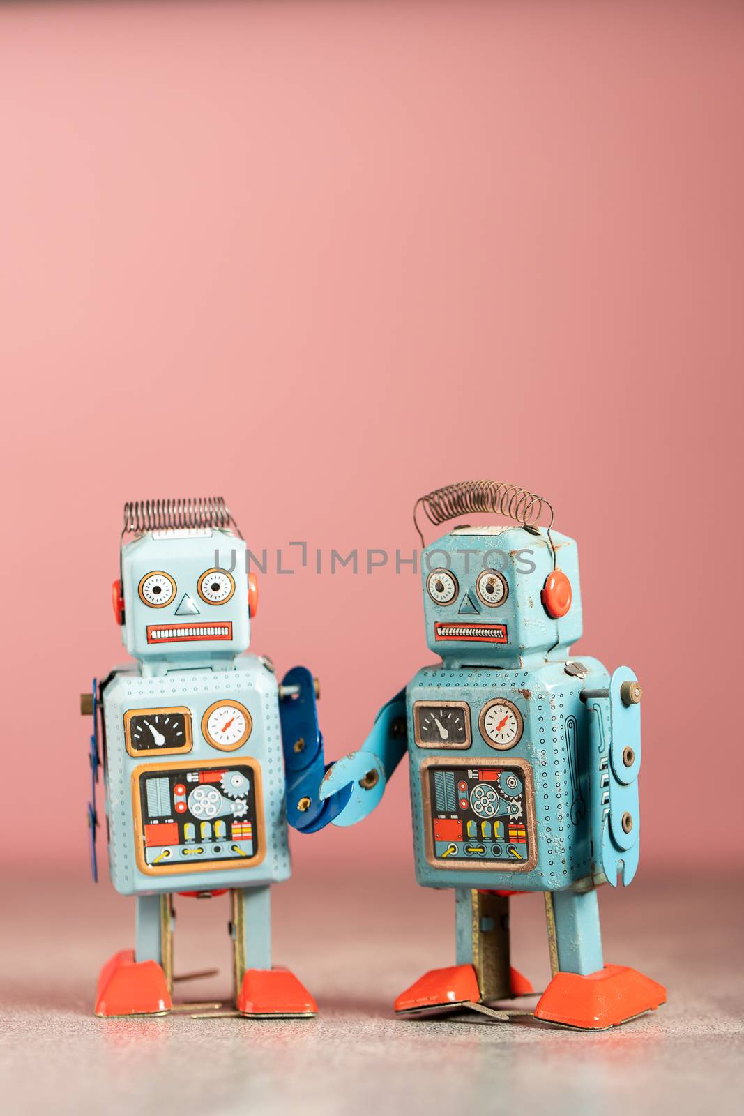 Vintage robot tin toy on pink background