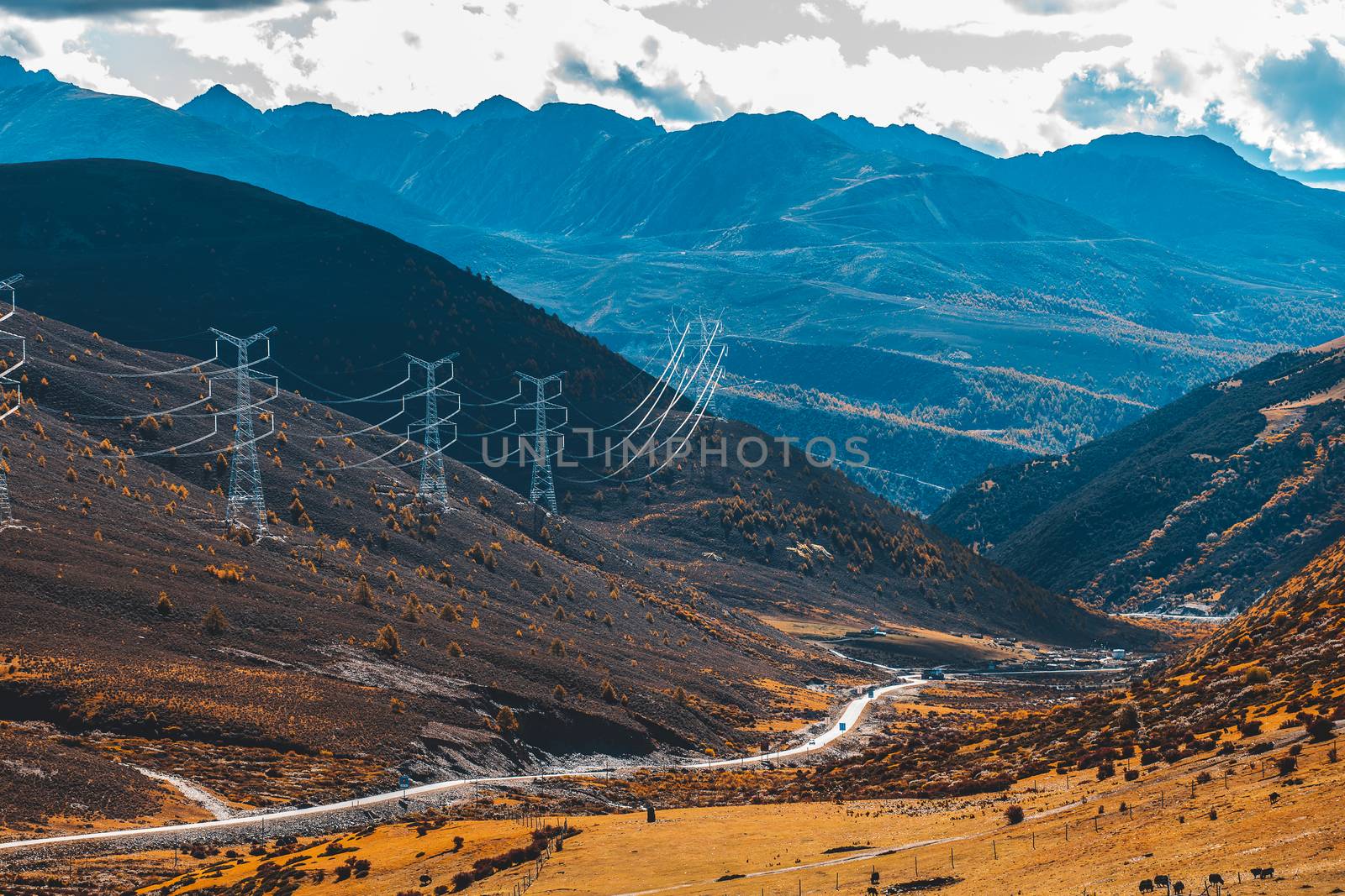 Colorful landscape with beautiful mountain road with a perfect asphalt. High rocks, blue sky at sunrise in summer