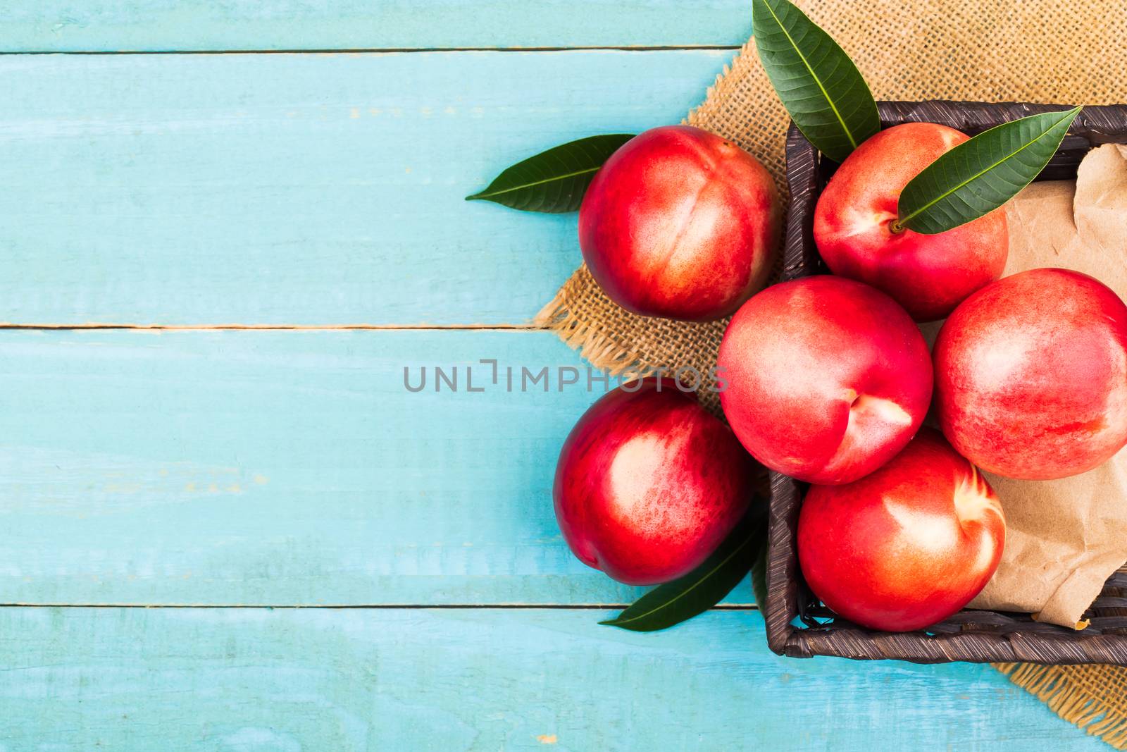 Sweet nectarine on wooden background by freedomnaruk