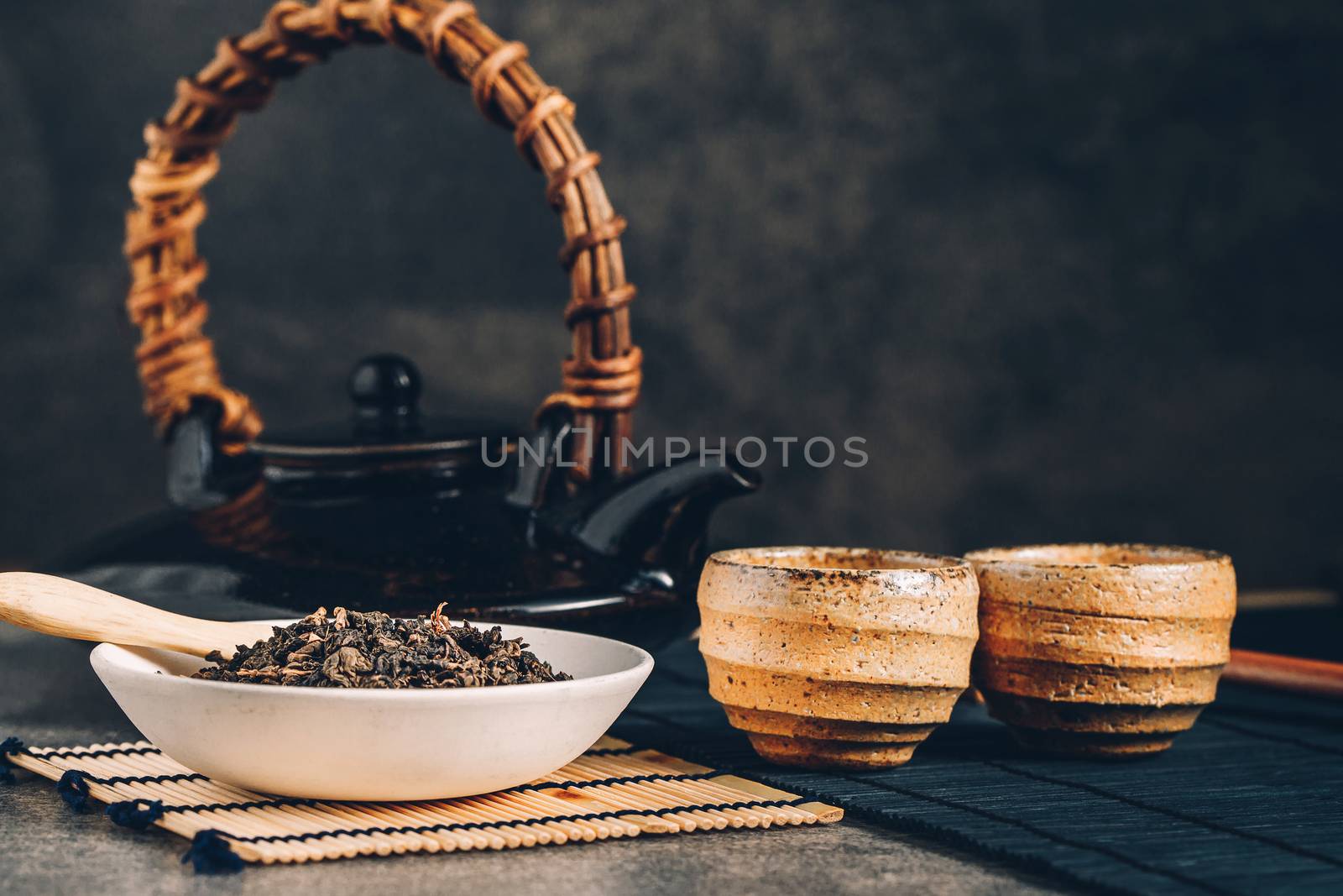 Hot tea in glass teapot and cup with steam