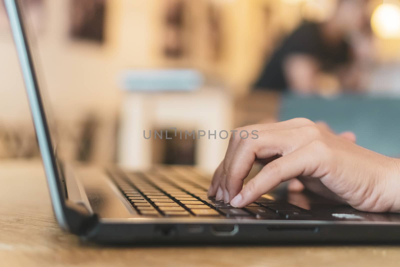 Woman hand using laptop to work study on work desk with clean nature background background. Business, financial, trade stock maket and social network. by Suwant