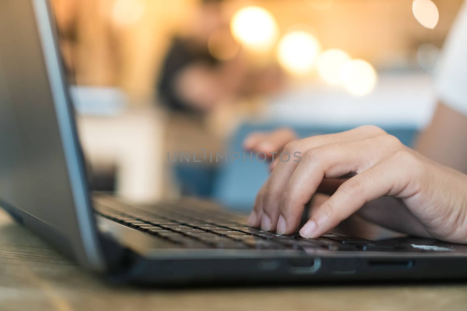 Woman hand using laptop to work study on work desk with clean nature background background. Business, financial, trade stock maket and social network concept.