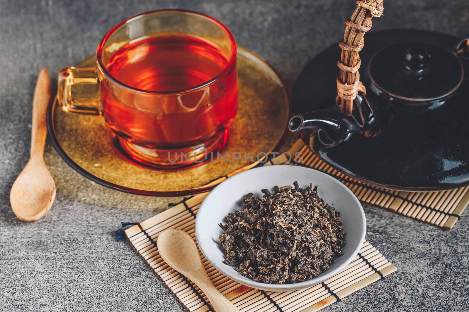 Hot tea in glass teapot and cup with steam