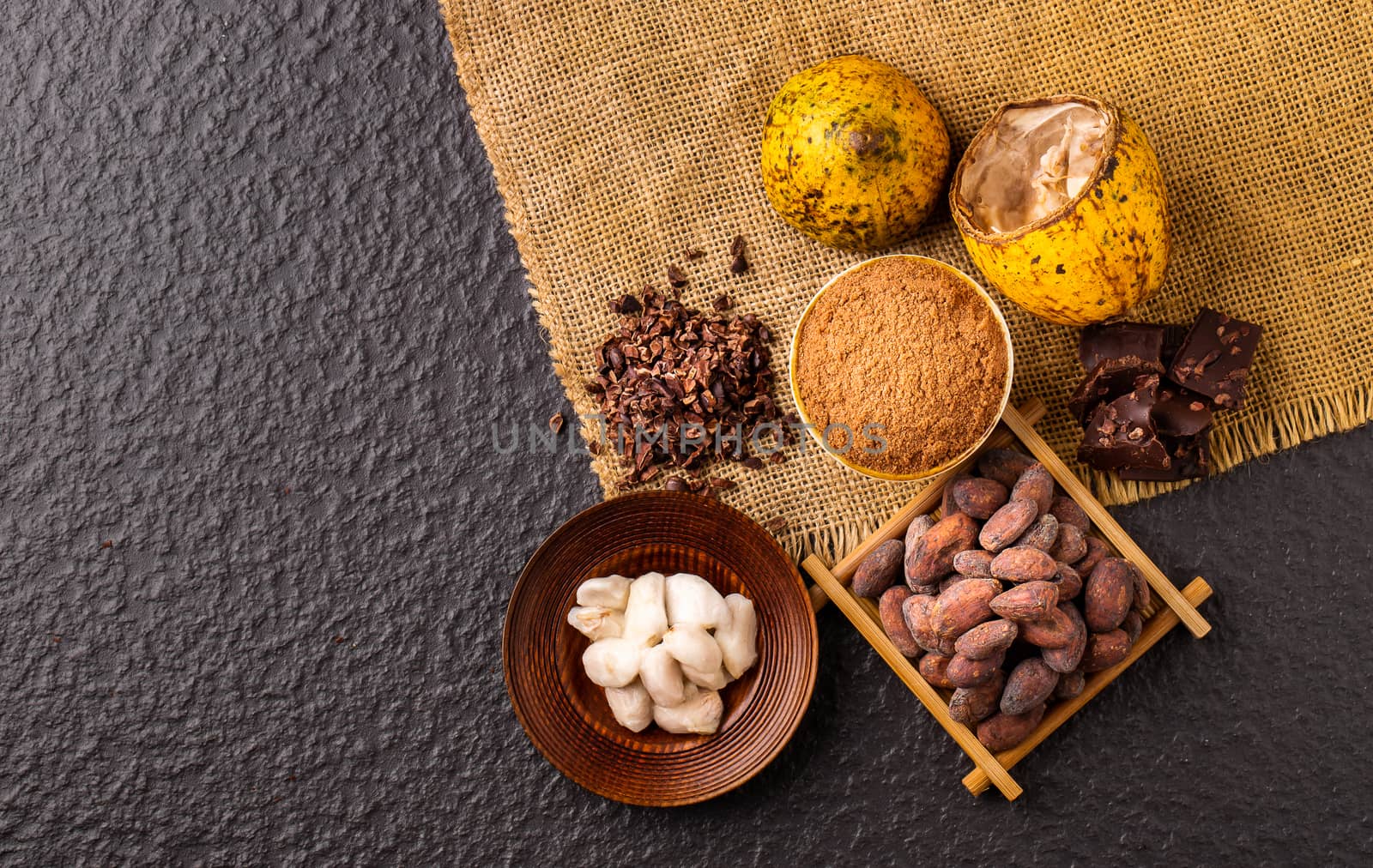 Dark chocolate pieces crushed and cocoa beans, top view