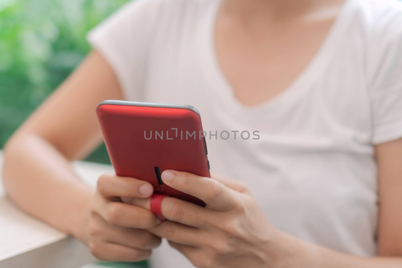 Woman hand use smartphone to do work business, social network, communication in public cafe work space area.