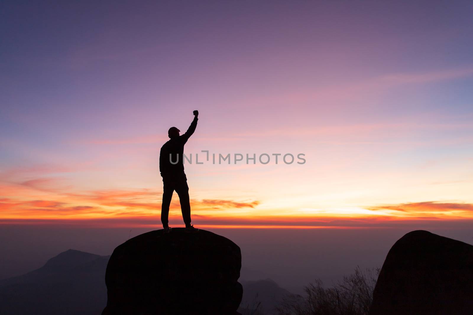  travels Silhouette on the peak of mountain,success concept by freedomnaruk