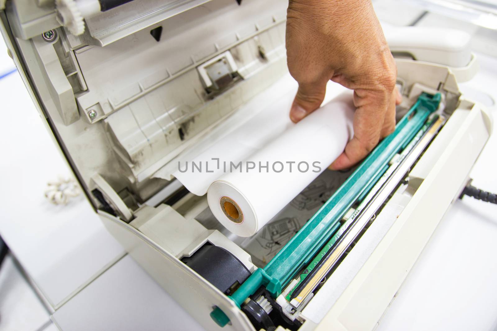 Hand of Man hold Fax paper setup to fax machine