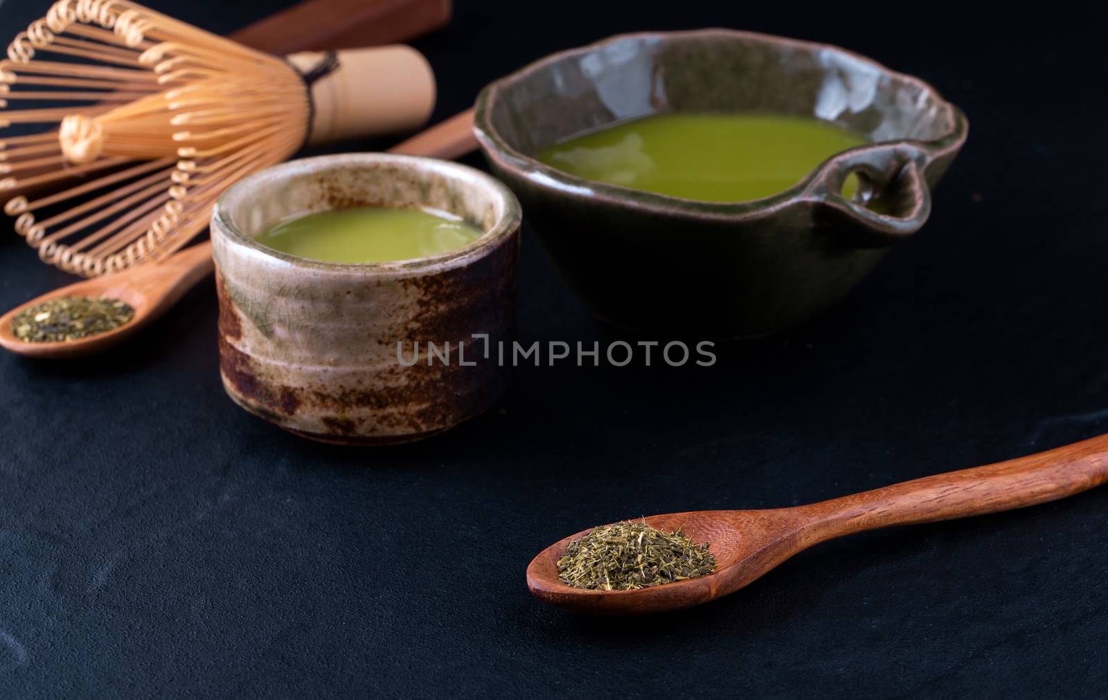 green tea matcha in a bowl on wooden surface by freedomnaruk