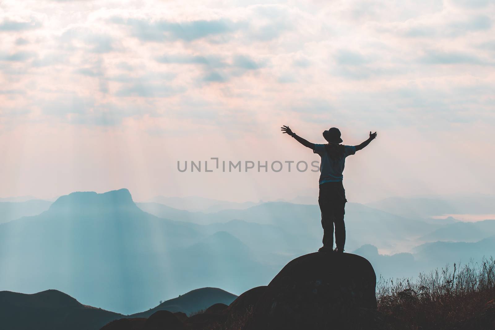 travels Silhouette on the peak of mountain,success concept