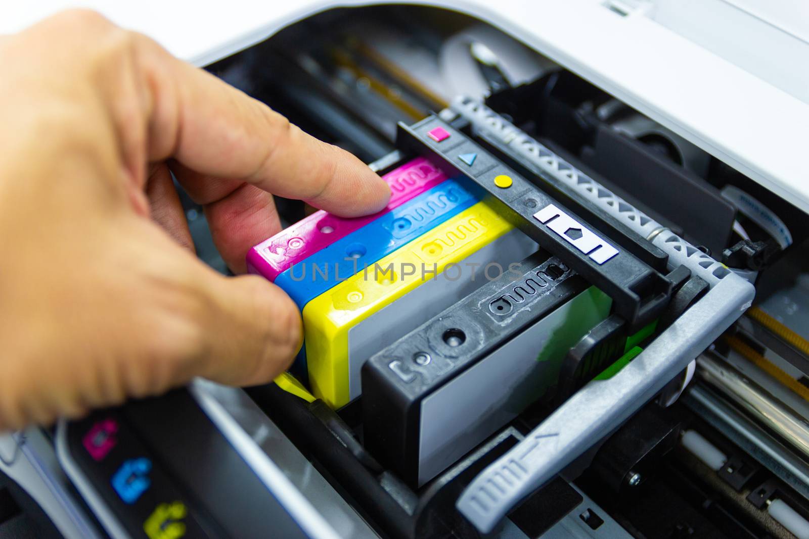 Technicians are install setup the ink cartridge or inkjet cartridge is a component of an inkjet printer 