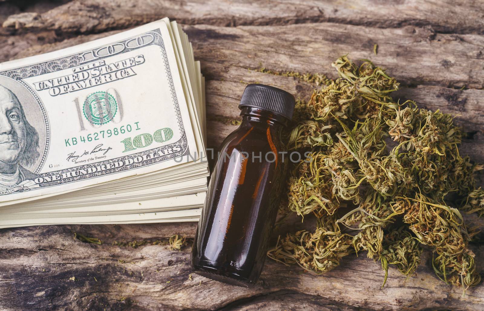 dried medical marijuana with CBD  THC extract and dollar bill by anankkml