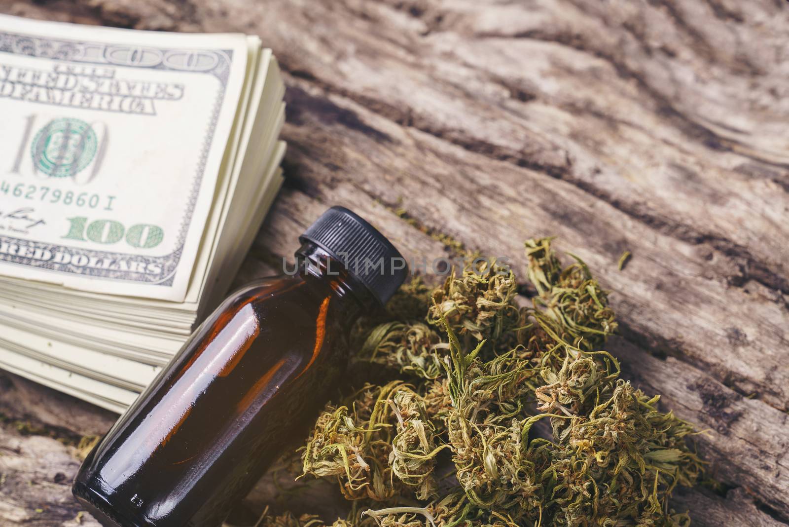 dried medical marijuana with CBD  THC extract and dollar bill by anankkml