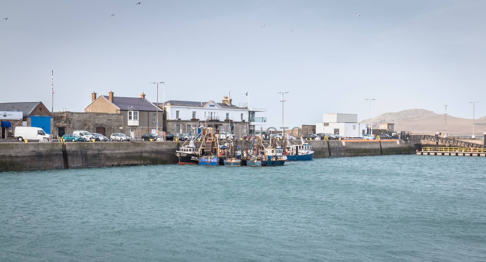 Howth near Dublin, Ireland - February 15, 2019: view of the fishing port of the city where are parked professional fishing boats on a winter day